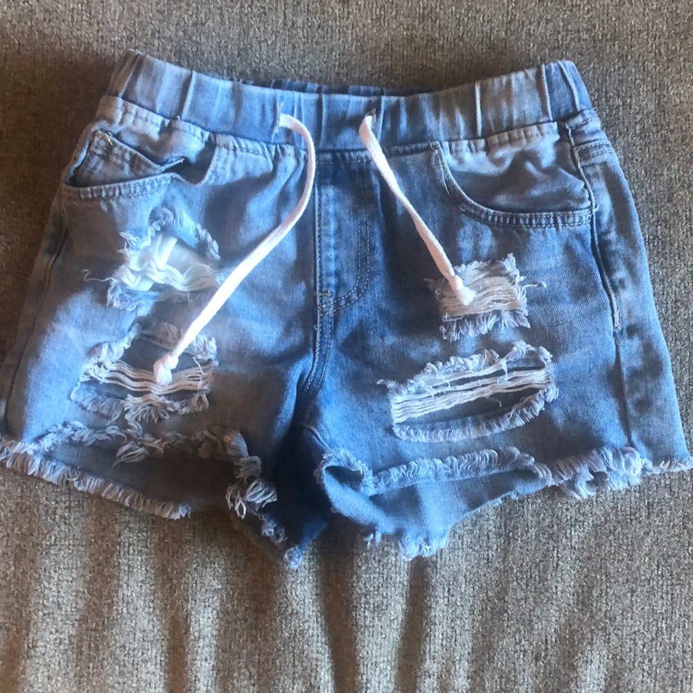 Light colored blue Jean shirts with rips. Size x small. Draw string . YMI brand